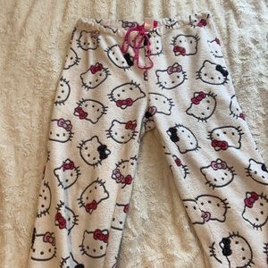 Women’s white Hello Kitty Pajama Pants with pink drawstring & ruffled bottoms.